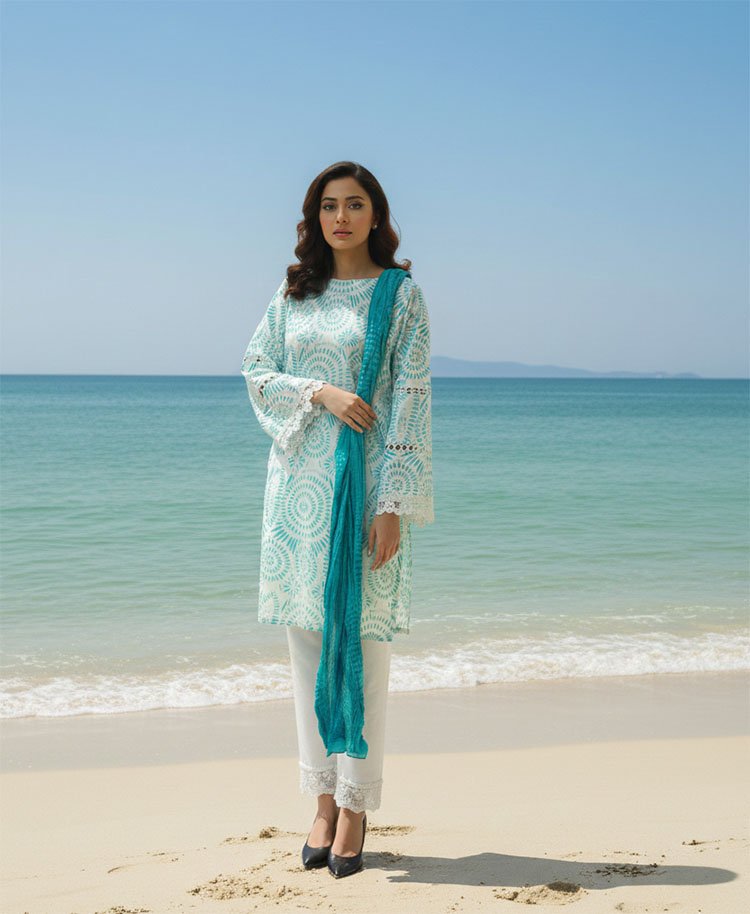 wearing a white and teal patterned tunic with lace detailing