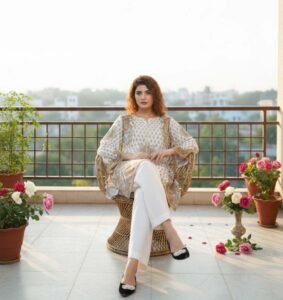 Ivory Paisley Silk Symphony 2-piece set, featuring a stunning silk tunic with gold and teal paisley motifs and matching white wide-leg trousers.