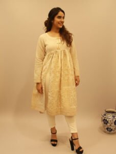 Gilded Ivory Lawn Frock, an exquisite off-white lawn one-piece frock featuring stunning gold block-printed patterns, a pleated empire waist, and radiant textured sleeves.