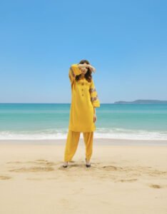 Patchwork Breeze, a stunning 2-piece sky blue lawn suit featuring exquisite hand-worked patches on the sleeves and matching tailored trousers.