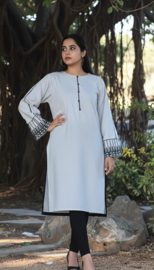 Slate Urban Nomad kurta, a stunning light grey khadder piece featuring exquisite hand work tribal patches on the sleeves and a sleek Western silhouette.