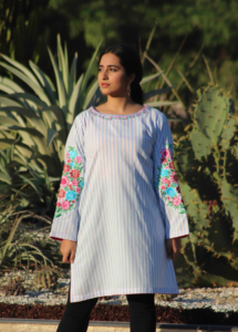 Azure Bloom Striped Kurta, a stunning 1-piece blue and white striped lawn kurta featuring exquisite machine embroidery on the neck and sleeves with vibrant pink and blue floral motif