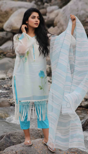 Azure Bloom Lawn Ensemble, a stunning 3-piece white lawn suit featuring vibrant turquoise floral hand-painted art, a long fringe hem, and a matching striped organza dupatta