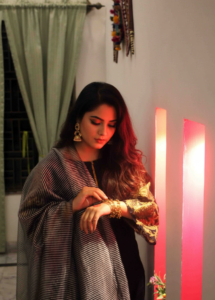 Obsidian Gilded Lawn 3-piece suit, featuring a black lawn kurta with exquisite gold hand work on the sleeves, matching trousers, and a silver and gold striped dupatta.