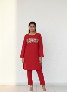 Crimson Hand-Worked Aura kurta, a stunning deep red khadder piece featuring exquisite hand work floral motifs across the chest and a sleek tailored silhouette.