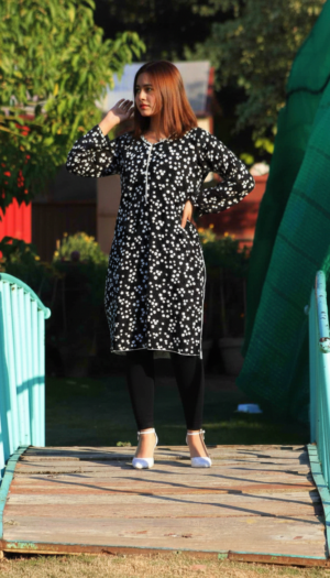 floral kurta set in black linen with a white daisy print and matching black leggings.