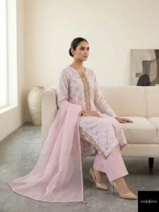 Celestia Monolith, a stunning 3-piece ensemble featuring a premium lawn shirt with exquisite silk-tassel sleeves, paired with luxurious silk straight trousers and a sheer radiant organza dupatta.